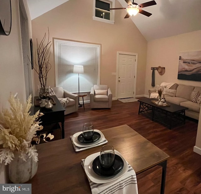 living room featuring ceiling fan, dark hardwood / wood-style flooring, and high vaulted ceiling