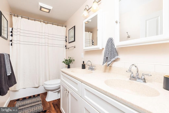 full bathroom with vanity, hardwood / wood-style flooring, toilet, and shower / bath combo with shower curtain