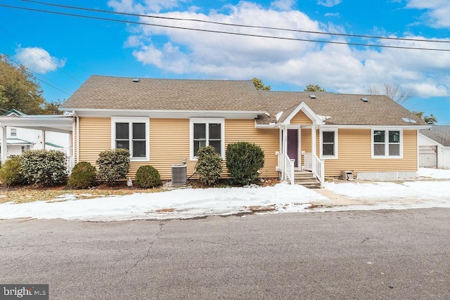 view of front of home featuring a carport and central air condition unit