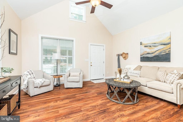 living room featuring wood-type flooring, ceiling fan, and high vaulted ceiling