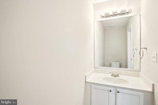 bathroom with vanity and toilet