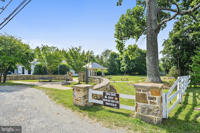 exterior space featuring a lawn, a gazebo, and fence