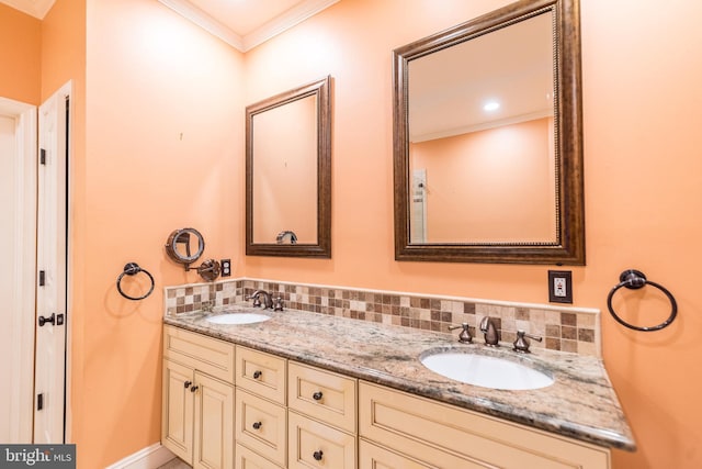 bathroom featuring crown molding, tasteful backsplash, and vanity