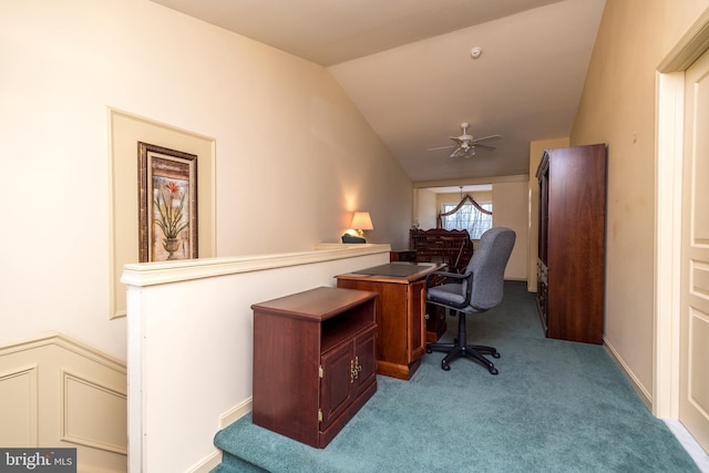 carpeted home office featuring vaulted ceiling