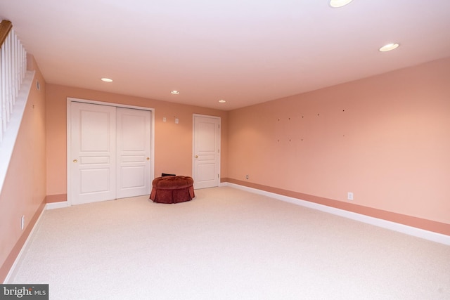 unfurnished bedroom with light colored carpet and a closet