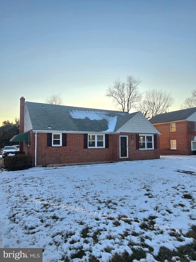 view of snow covered back of property