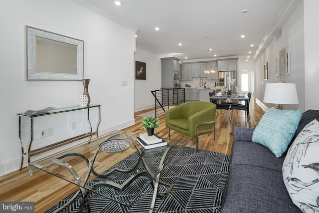 living room with light hardwood / wood-style floors and ornamental molding