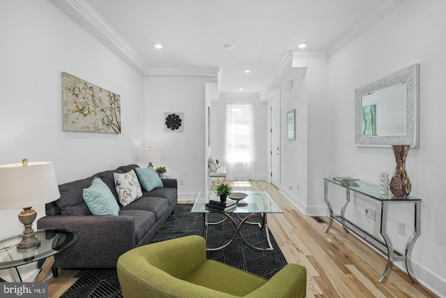 living room with ornamental molding and light hardwood / wood-style flooring