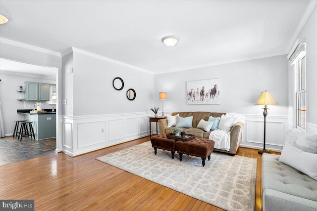 living room featuring light hardwood / wood-style floors and ornamental molding