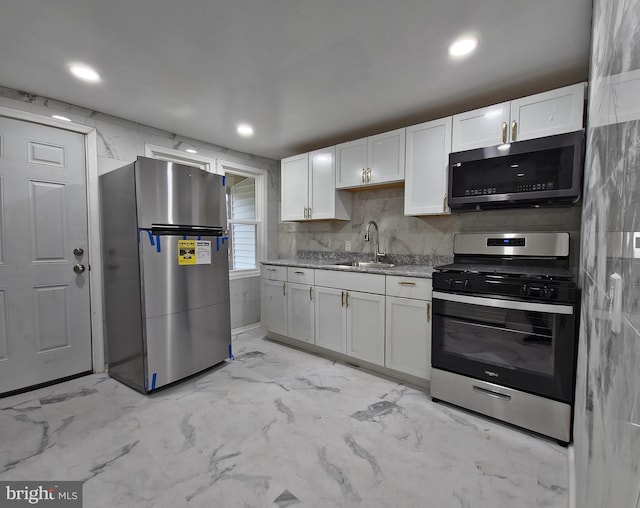 kitchen with sink, white cabinets, and stainless steel appliances