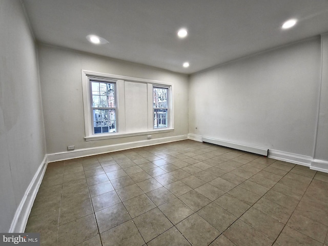 unfurnished room featuring tile patterned flooring and baseboard heating