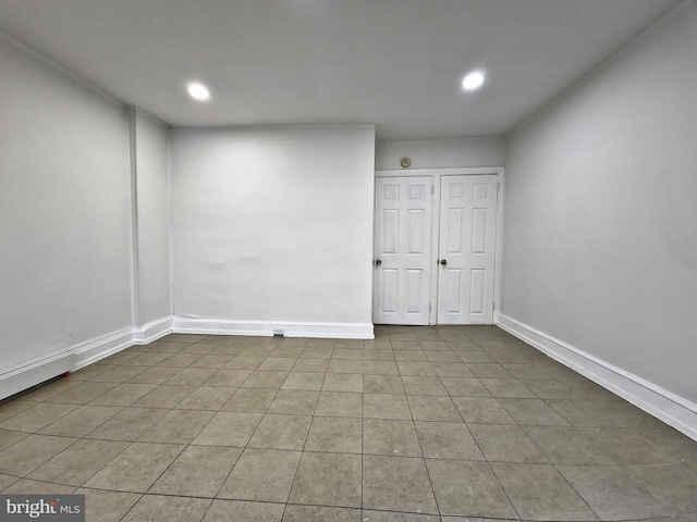 tiled empty room featuring a baseboard radiator