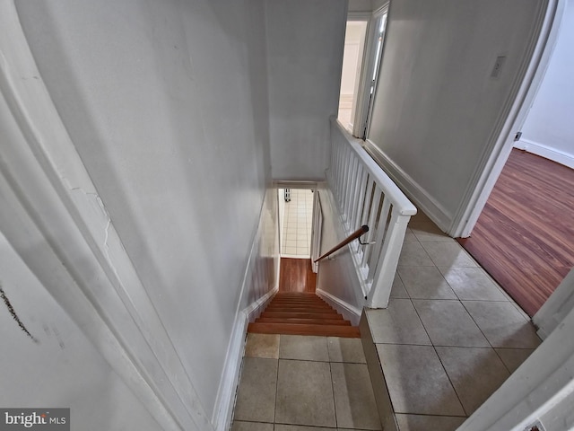 staircase featuring tile patterned floors