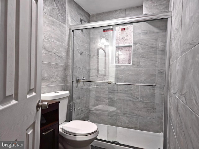 bathroom with toilet and a shower with door