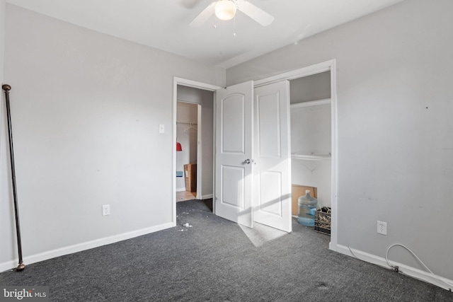 unfurnished bedroom with ceiling fan, a closet, and dark carpet