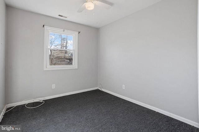 carpeted spare room featuring ceiling fan