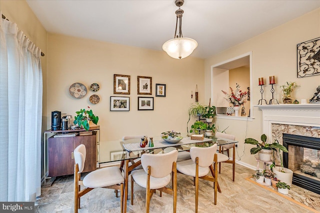 dining space featuring a premium fireplace