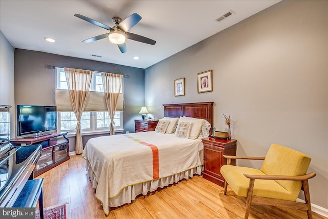 bedroom with ceiling fan and light hardwood / wood-style flooring