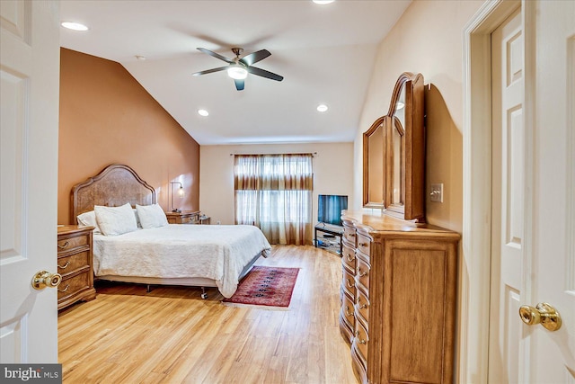 bedroom with ceiling fan, light hardwood / wood-style flooring, and lofted ceiling