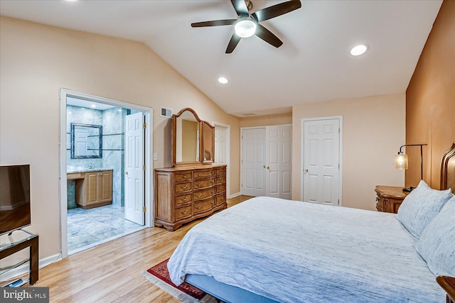 bedroom with ceiling fan, lofted ceiling, light hardwood / wood-style flooring, and ensuite bath