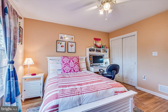 bedroom featuring ceiling fan, a closet, and hardwood / wood-style flooring