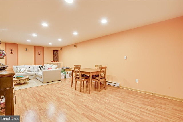 dining room with light hardwood / wood-style floors and a baseboard radiator