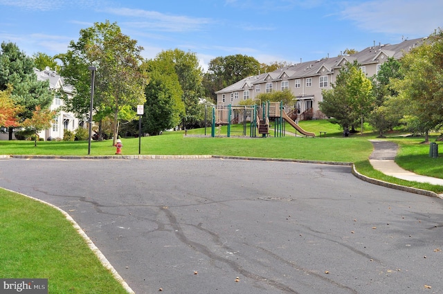 exterior space featuring a lawn and a playground