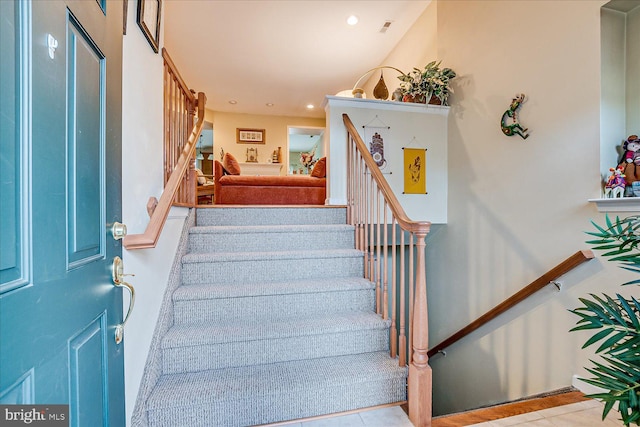 stairway with tile patterned flooring