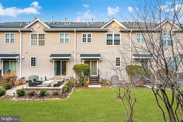 back of property with central AC unit, a patio, and a yard