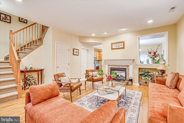 living room with a fireplace and hardwood / wood-style flooring