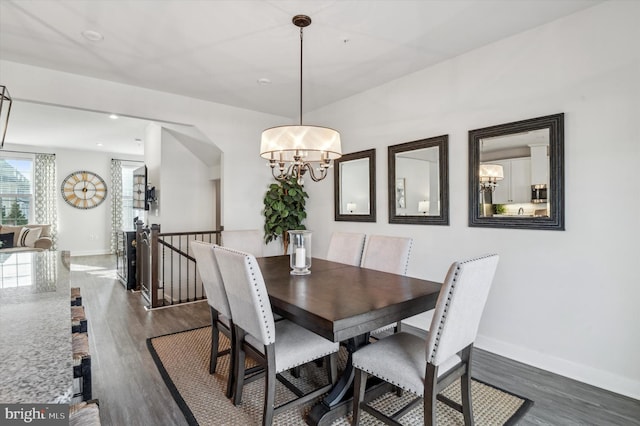 dining area featuring a notable chandelier and dark hardwood / wood-style floors