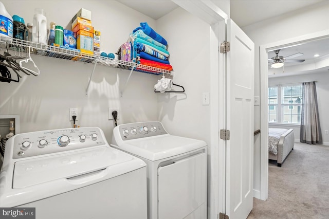 laundry area featuring washing machine and dryer, ceiling fan, and carpet flooring