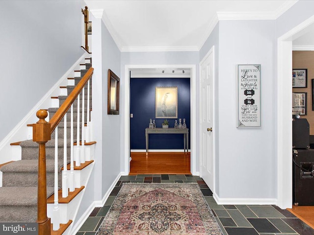 foyer entrance featuring crown molding