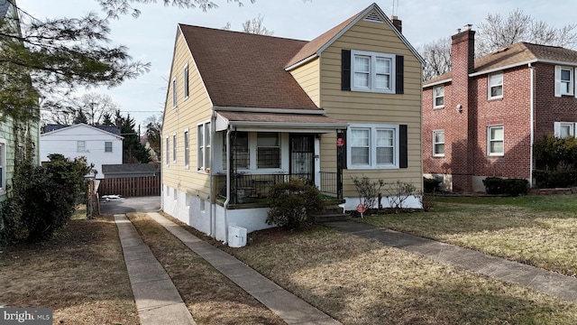 bungalow-style house with a front lawn and a porch