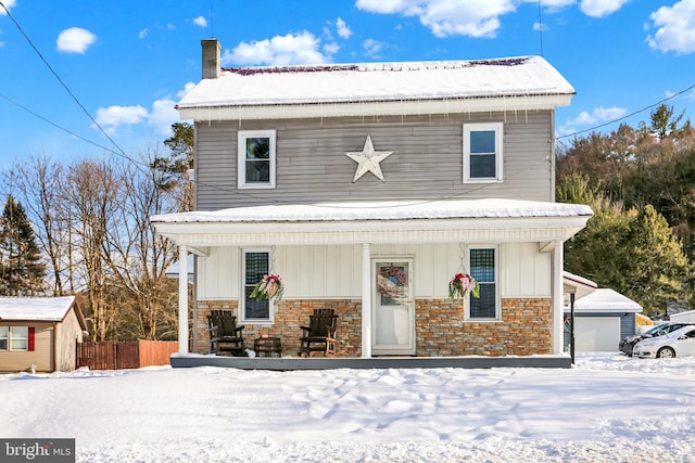 view of front of home with covered porch and a storage unit