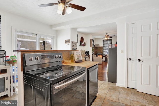 kitchen featuring ceiling fan and stainless steel appliances