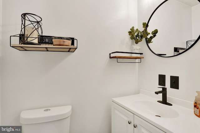 bathroom with toilet and vanity