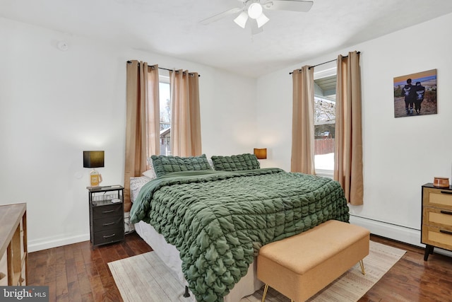 bedroom featuring ceiling fan, dark hardwood / wood-style flooring, and baseboard heating