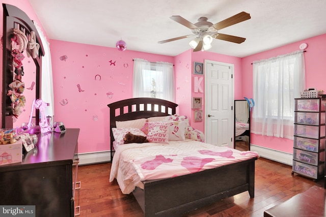 bedroom featuring ceiling fan, dark hardwood / wood-style floors, and a baseboard radiator