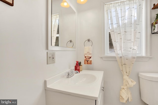 bathroom featuring toilet and vanity