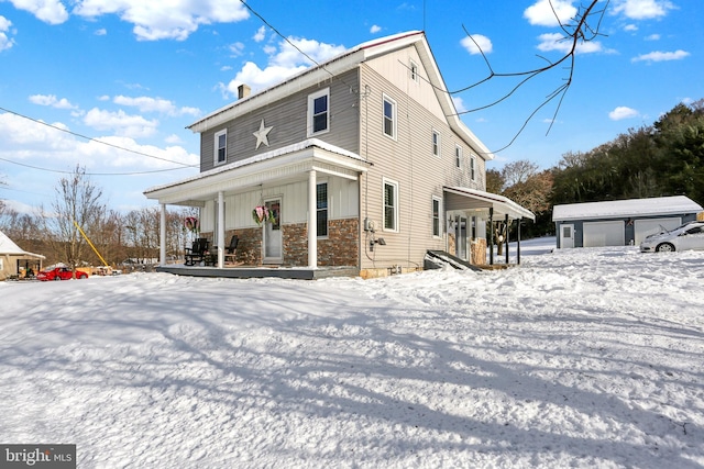 exterior space featuring an outbuilding, covered porch, and a garage