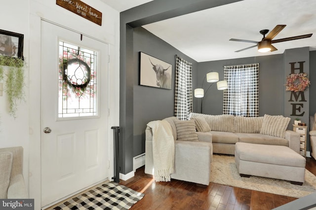 living room with ceiling fan, baseboard heating, and dark hardwood / wood-style floors