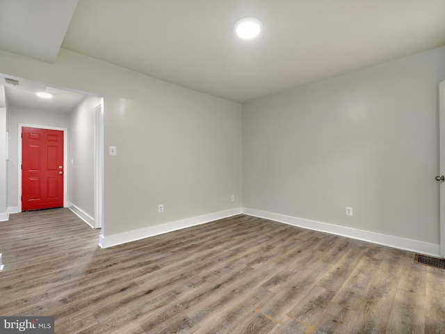 empty room with hardwood / wood-style floors