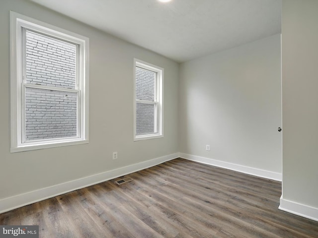 unfurnished room with dark hardwood / wood-style floors