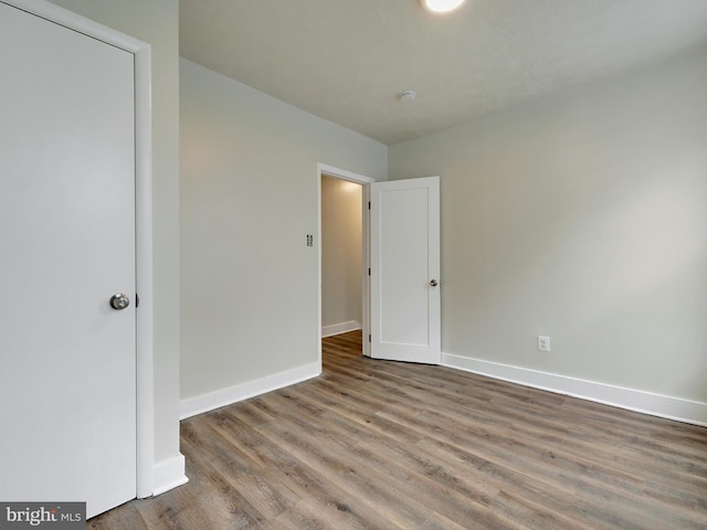 unfurnished bedroom with wood-type flooring