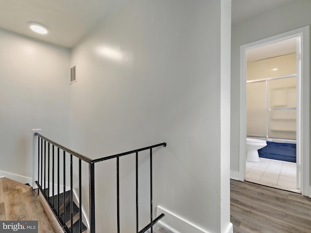 stairway with hardwood / wood-style floors