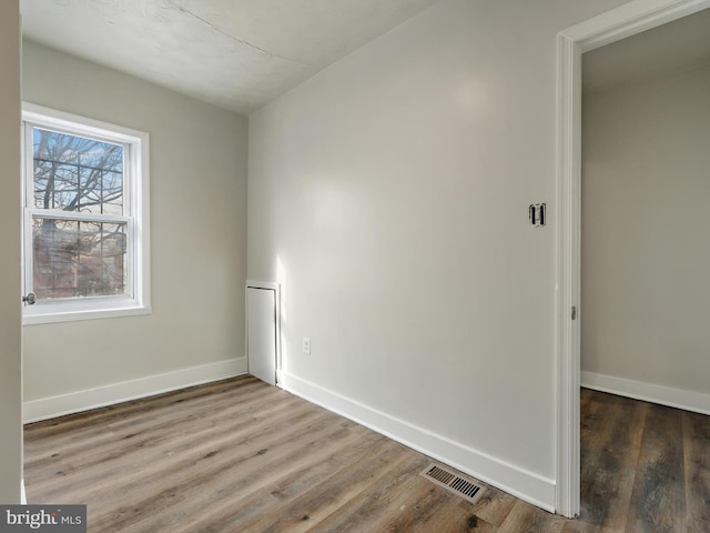 unfurnished room featuring hardwood / wood-style flooring