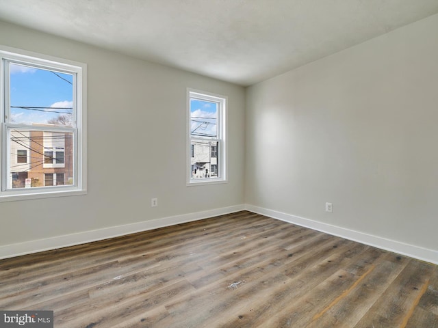 spare room with dark wood-type flooring