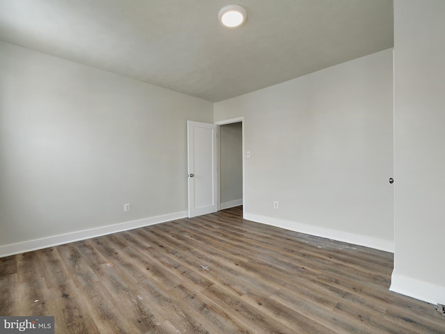 spare room with dark hardwood / wood-style floors