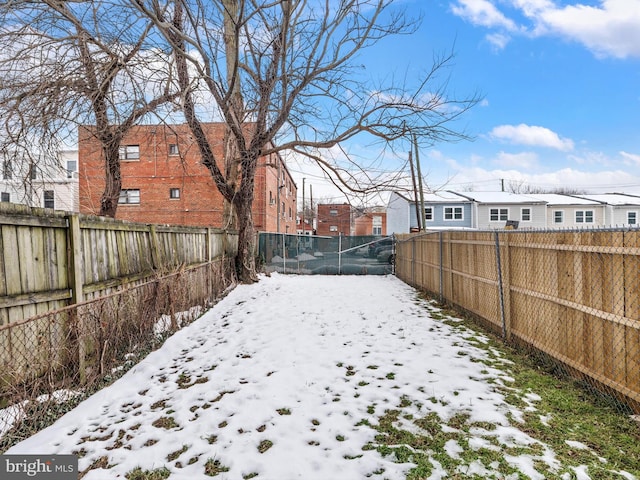 view of yard layered in snow